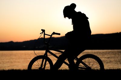 boy sittin gon bike looking sad